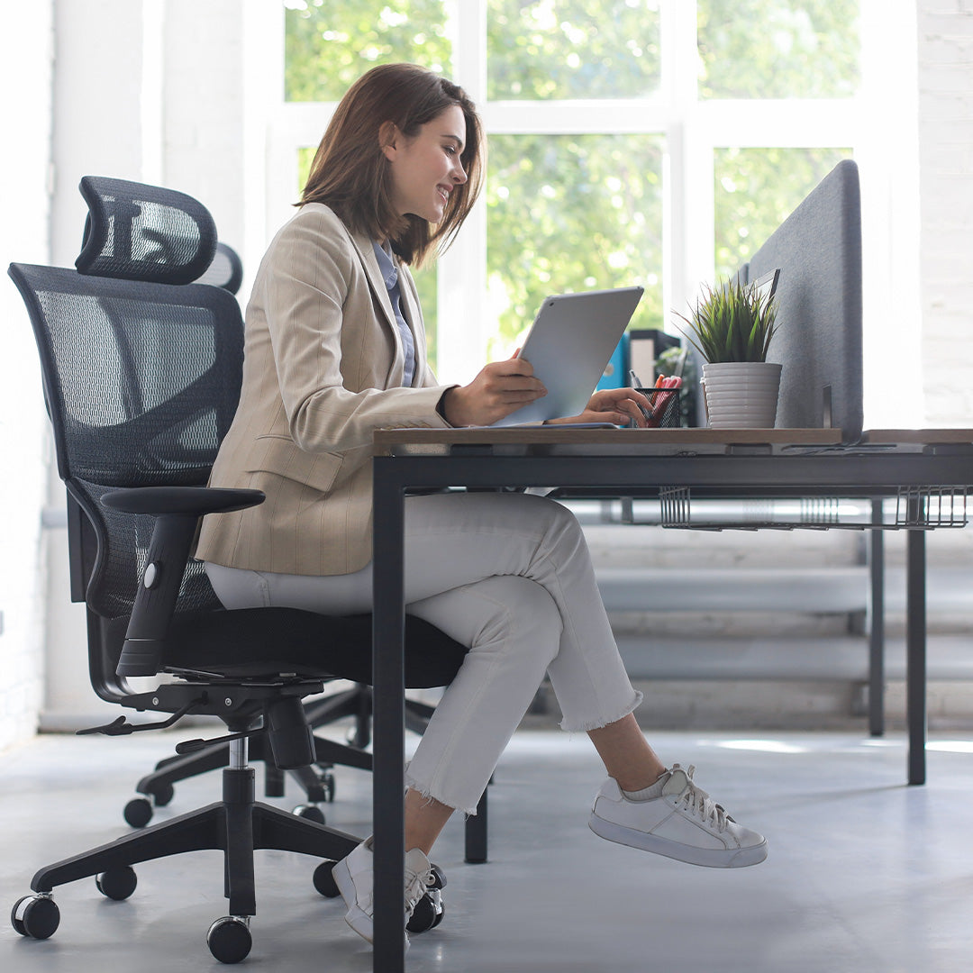 Woman using ergonomic office furniture at Cellini.