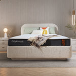 Cellini Nightingale orthopedic mattress on upholstered bed in cozy neutral bedroom with beige headboard, layered pillows and warm ambient lighting
