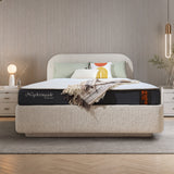 Cellini Nightingale orthopedic mattress on upholstered bed in cozy neutral bedroom with beige headboard, layered pillows and warm ambient lighting