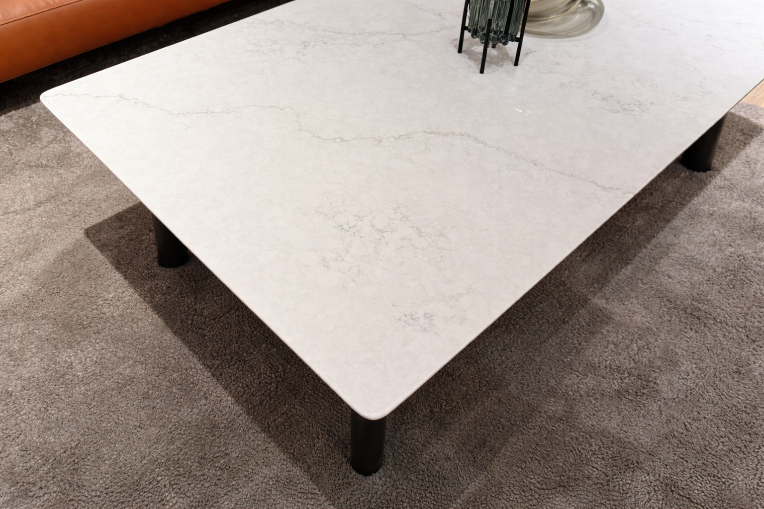 White marble coffee table with rounded edges on carpet in modern living room
