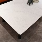 White marble coffee table with rounded edges on carpet in modern living room